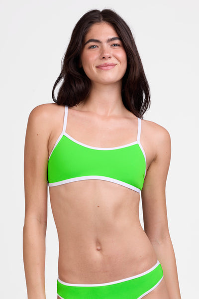 Female model wearing the Women's Jocelyn Bikini Top in the Lime contrast, standing in front of a grey background shown from the front view

|| Size S, Bust 31"  
