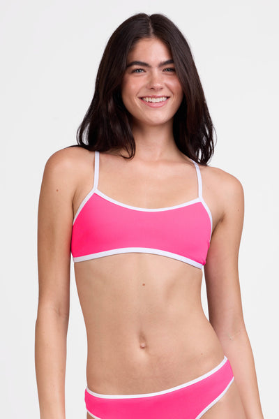 Female model wearing the Women's Jocelyn Bikini Top in the Pink Prism contrast, standing in front of a grey background shown from the front view

|| Size S, Bust 31"  
