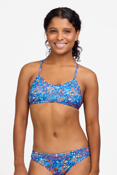 Female model wearing the Women's Natalie Bikini Bottom in the Calendula print, standing in front of a grey background shown from the front view 

|| Size S, Bust 32.5"