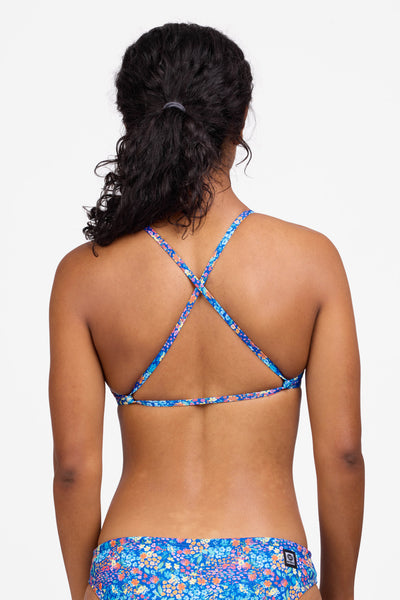 Female model wearing the Women's Natalie Bikini Bottom in the Calendula print, standing in front of a grey background shown from the back view 

|| Size S, Bust 32.5"