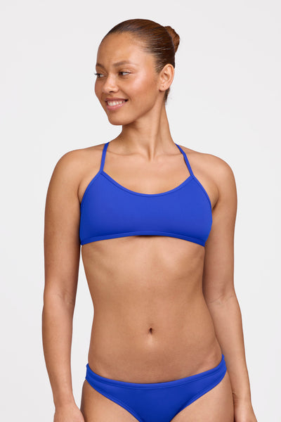 Female model wearing the Women's Ryan Bikini Top in the Blueberry solid, standing in front of a grey background shown from the front view

|| Size L, Bust 35"