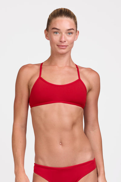 Female model wearing the Women's Ryan Bikini Top in the Red solid, standing in front of a grey background shown from the front view

|| Size S, Bust 33"