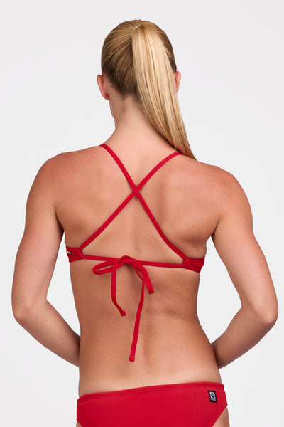 Female model wearing the Women's Ryan Bikini Top in the Red solid, standing in front of a grey background shown from the back view

|| Size S, Bust 33"