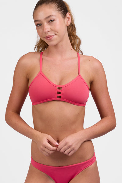Female model wearing the Women's Tomcat Bikini Top in the Guava Crush solid, standing in front of a grey background, shown from the front view

|| Size M, Bust 33"  