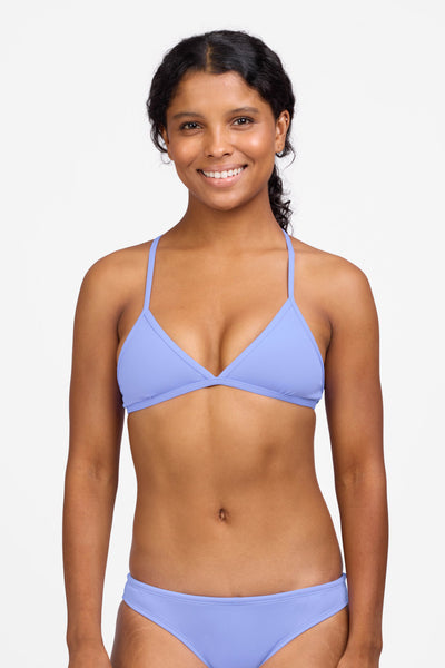 Female model wearing the Women's Triangle Bikini Top in the Lavender solid, standing in front of a grey background shown from the front view

|| Size S, Bust 32.5"