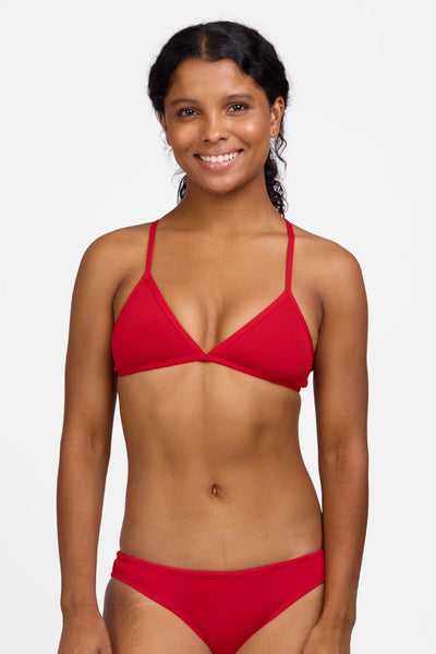 Female model wearing the Women's Triangle Bikini Top in the Red solid, standing in front of a grey background shown from the front view

|| Size S, Bust 32.5"