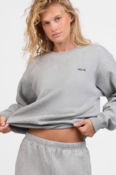 Female model wearing the Women's Ellison Crewneck in the Heather Grey solid, standing in front of a grey background, shown from the front view

|| Size S, Bust 31.5"  