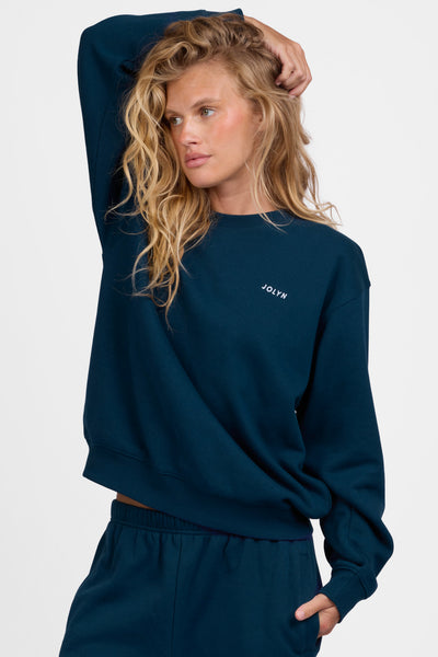 Female model wearing the Women's Ellison Crewneck in the Indigo solid, standing in front of a grey background, shown from the front view

|| Size M, Bust 31.5"  