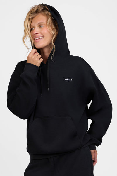 Female model wearing the Women's Lana Hoodie in the Black solid, standing in front of a grey background, shown from the front view

|| Size S, Bust 31.5"  