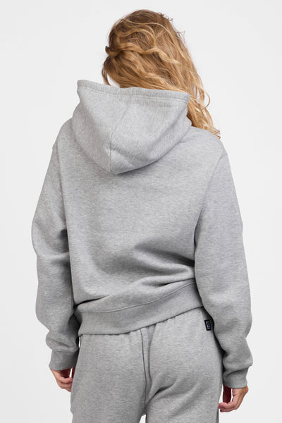 Female model wearing the Women's Lana Hoodie in the Heather Grey solid, standing in front of a grey background, shown from the back view


|| Size S, Bust 31.5"  