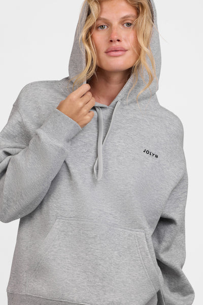 Female model wearing the Women's Lana Hoodie in the Heather Grey solid, standing in front of a grey background, shown from the front view

|| Size S, Bust 31.5"  