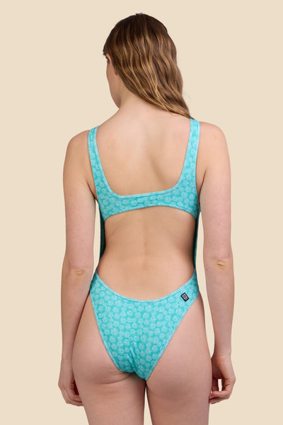 Female model wearing the Women's Catherine Onesie in the Clamshell Ribbed print, standing in front of a yellow background shown from the back view

|| Size S, Torso 61"  

