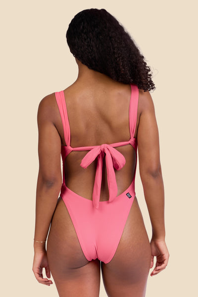 Female model wearing the Women's Jiro One Piece Swimsuit in the Tea Rose Ribbed solid, standing in front of a yellow background shown from the back view

|| Size S, Torso 59 1/2"  