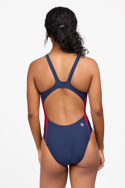 Female model wearing the Women's Amelie One Piece Swimsuit in the Navy Contrast, standing in front of a grey background shown from the back view

|| Size 30, Torso 59"