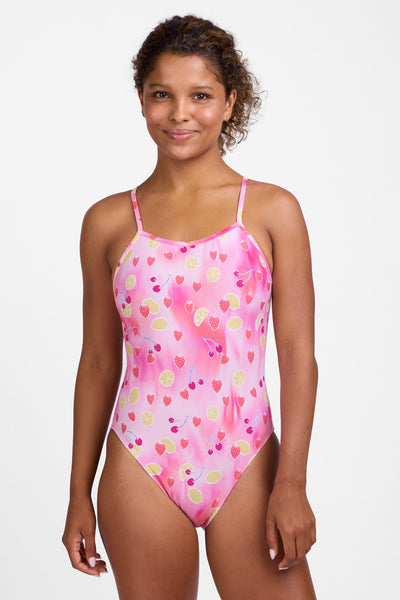 Female model wearing the Women’s Brandon One Piece Swimsuit in the Berry Zest print, standing in front of a grey background, shown from front view. 