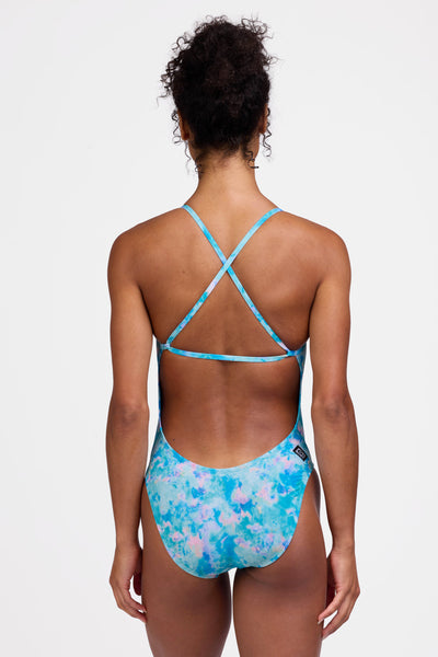 Female model wearing the Women's Brandon One Piece Swimsuit in the Cascade print, standing in front of a grey background shown from the back view

|| Size 28, Torso 56"