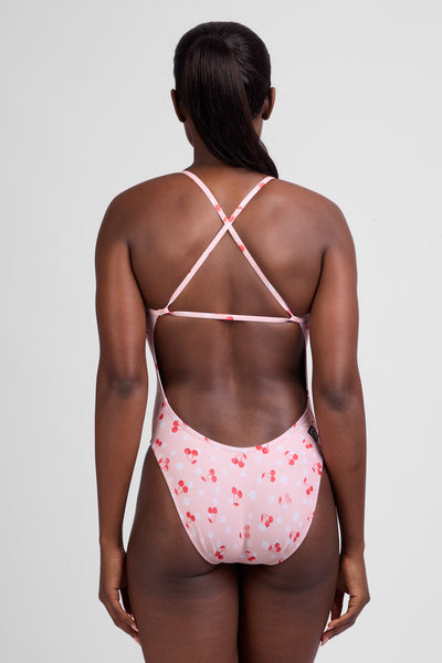 Female Model wearing the Women's Brandon One Piece Swimsuit in the Cherry Blossom print, standing in front of a grey background shown from the back view

|| Size 28, Torso 59"