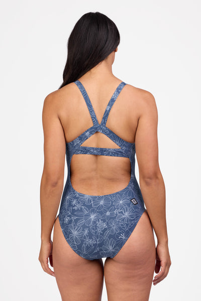 Female model wearing the Women's Caroline One Piece Swimsuit in the Calliope print, standing in front of a grey background shown from the back view

|| Size 30, Height 5'9"