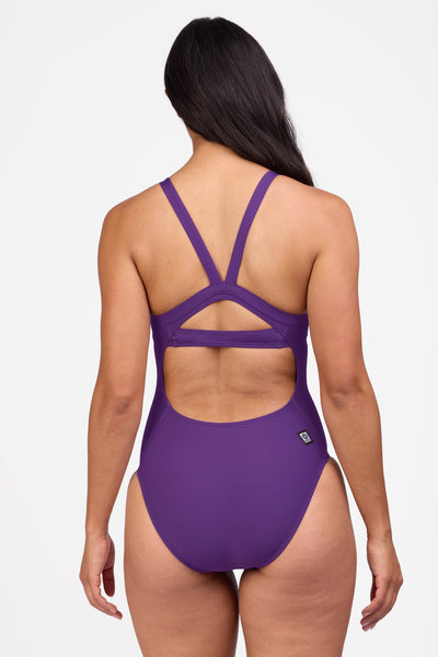 Female model wearing the Women's Caroline One Piece Swimsuit in the Grape solid, standing in front of a grey background shown from the back view

|| Size 30, Height 5'9"  