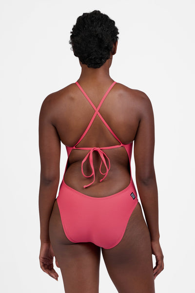 Female model wearing the Women's Jackson One Piece Swimsuit in the Guava Crush solid, standing in front of a grey background, shown from the back view

|| Size 30, Torso 60.5" 