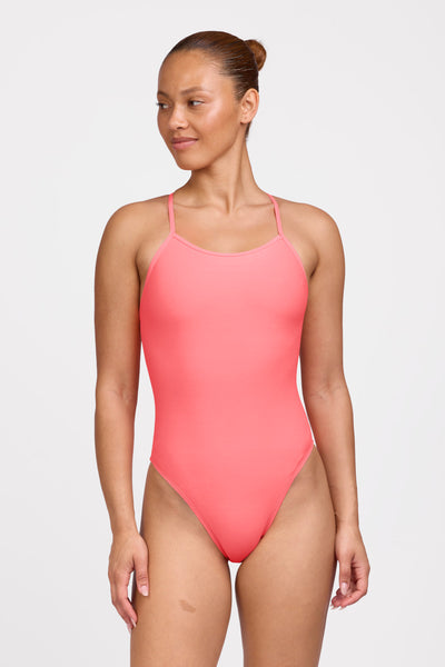 Female model wearing the Women's Jackson One Piece Swimsuit in the Papaya solid, standing in front of a grey background shown from the front view 

|| Size 32, Hip 62.5"  
