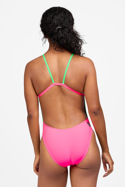 Female model wearing the Women's Kirsten One Piece Swimsuit in the Hot Pink contrast, standing in front of a grey background shown from the back view

|| Size 30, Torso 59"