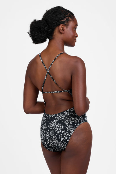 Female model wearing the Women's Marie One Piece Swimsuit in the Shells print, standing in front of a grey background shown from the side view

|| Size 30, Torso 60.5"  