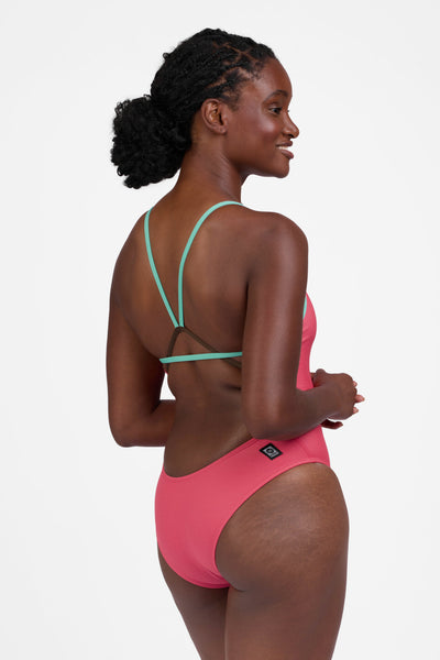 Female model wearing the Women's Perry One Piece Swimsuit in the Guava Crush contrast, standing in front of a grey background, shown from the side view

|| Size 30, Torso 60.5" 