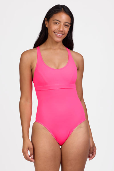 Female model wearing the Women's Toni One Piece Swimsuit in the Hot Pink solid, standing in front of a grey background shown from the front view

|| Size 30, Height 5'9"