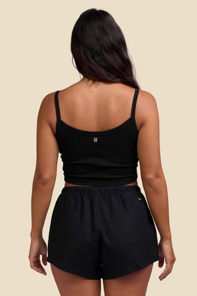 Female model wearing the Women's Kendall Short in the Black solid, standing in front of a yellow background shown from the back view

|| Size S, Hips 35"  