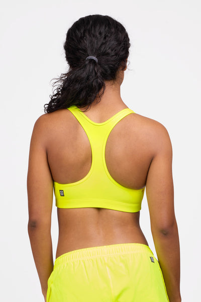 Female model wearing the Women's Molly Sports Bra in the Bolt solid, standing in front of a grey background shown from the back view

|| Size S, Bust 32.5"  