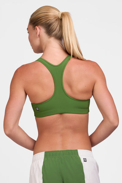 Female model wearing the Women's Molly Sports Bra in the Mountain Mist solid, standing in front of a grey background shown from the back view 

|| Size S, Bust 33"