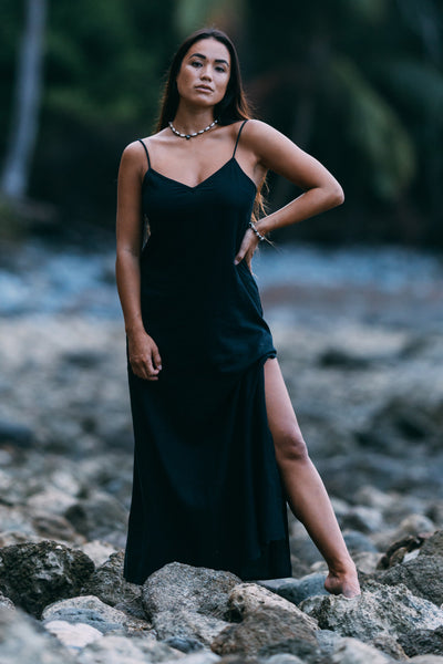 Female model wearing the Women's Lydia Dress in the Black solid, standing in front of a green background shown from the front view

|| Size S, Height 5'4"  