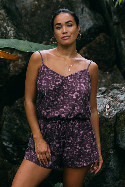 Female model wearing the Women's Naia Cover Up Romper in the Bondi Blossom print, standing in front of a green background shown from the front view

|| Size S, Height 5'4" 
