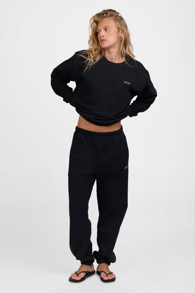 Female model wearing the Women's Melanie Sweat pant in the Black solid, standing in front of a grey background, shown from the front view

|| Size S, Hips 34.5"  