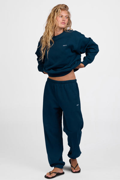 Female model wearing the Women's Melanie Sweat pant in the Indigo solid, standing in front of a grey background, shown from the front view

|| Size M, Hips 34.5"  