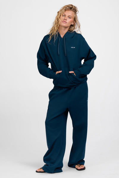 Female model wearing the Women's Nadia Sweat pant in the Indigo solid, standing in front of a grey background, shown from the front view

|| Size M, Hips 34.5"  