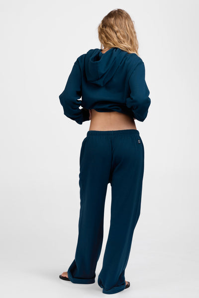 Female model wearing the Women's Nadia Sweat pant in the Indigo solid, standing in front of a grey background, shown from the back view

|| Size M, Hips 34.5"  